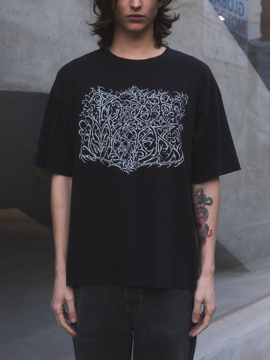 Model wearing Puppet Master oversized t-shirt by Mortisnoir — lifestyle lookbook shot in low light